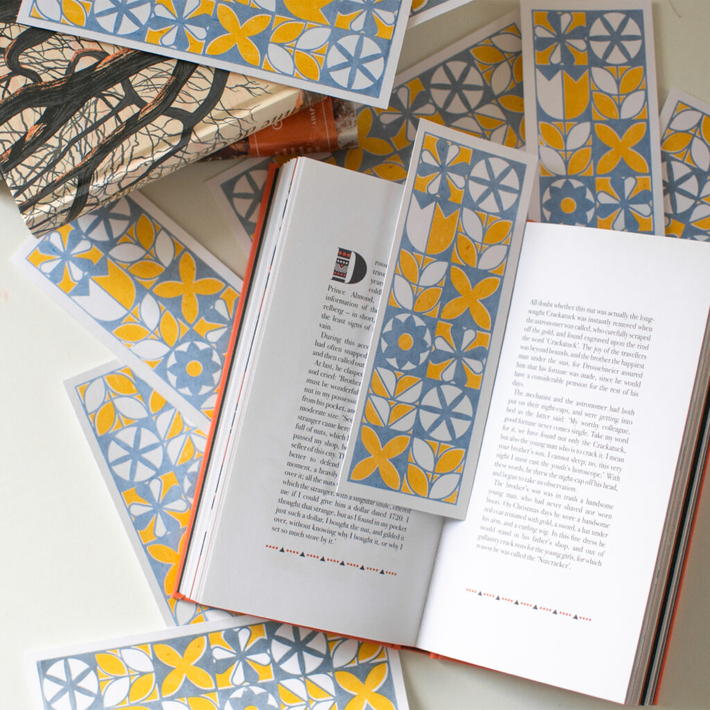 Marque page en sérigraphie, imprimé avec des encres naturelles jaune et bleu. Il représente des formes géométriques.